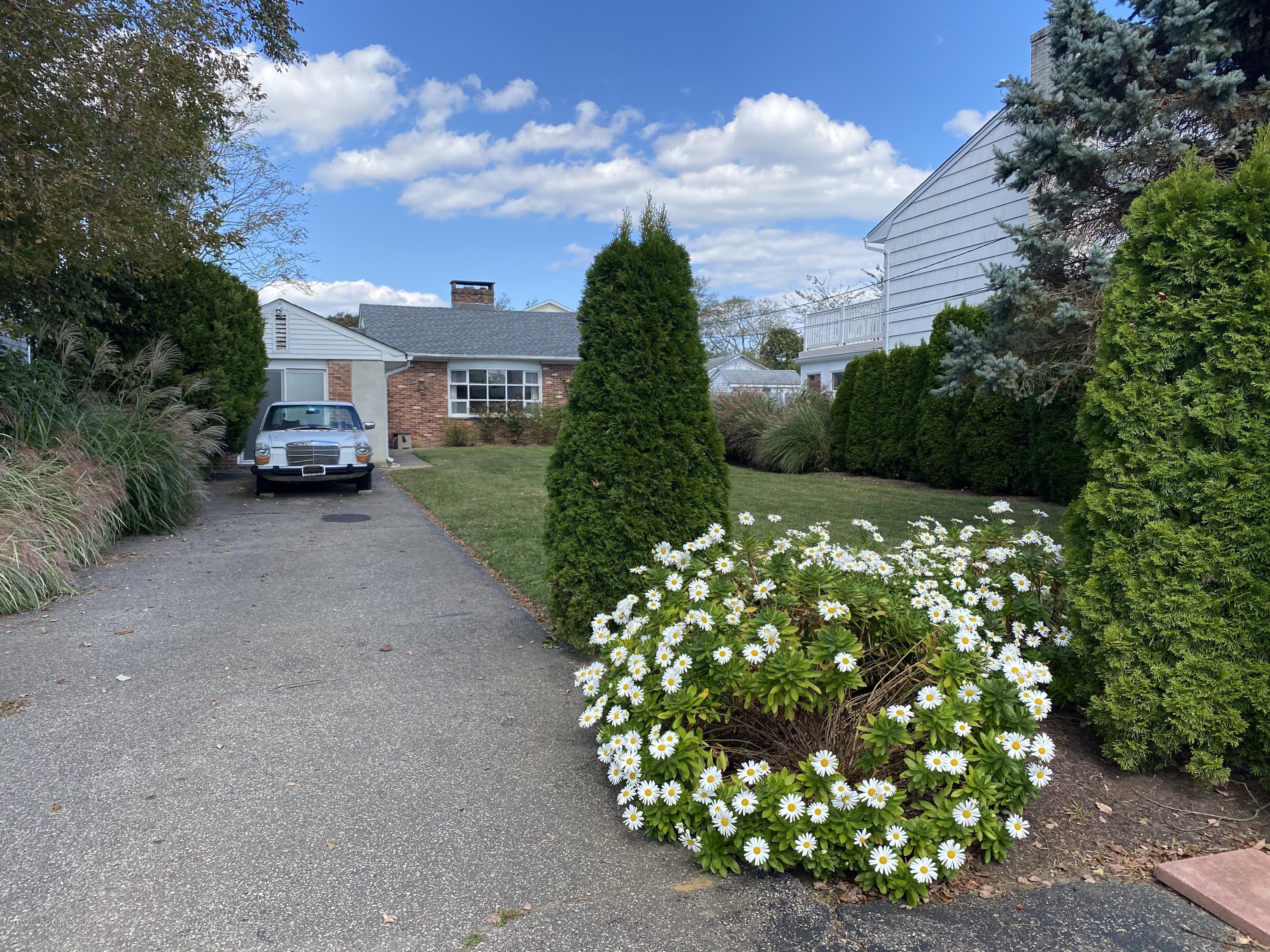 560 Central Avenue, Unit ANNUAL Spring Lake Heights, NJ 07762 - Photo 2 of 14 a view of a garden with a fountain