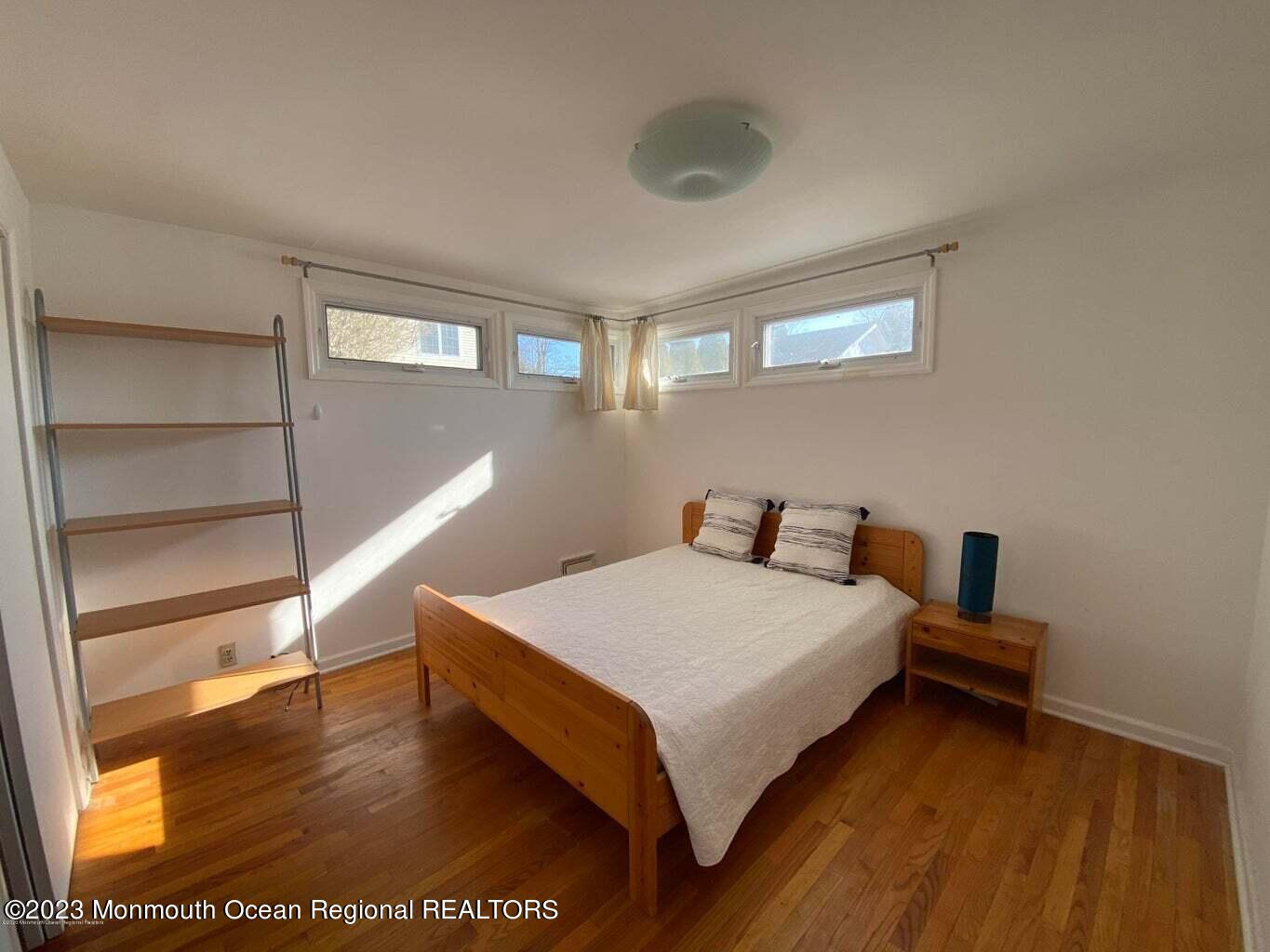 560 Central Avenue, Unit ANNUAL Spring Lake Heights, NJ 07762 - Photo 9 of 14 a bedroom with a bed and a night stand