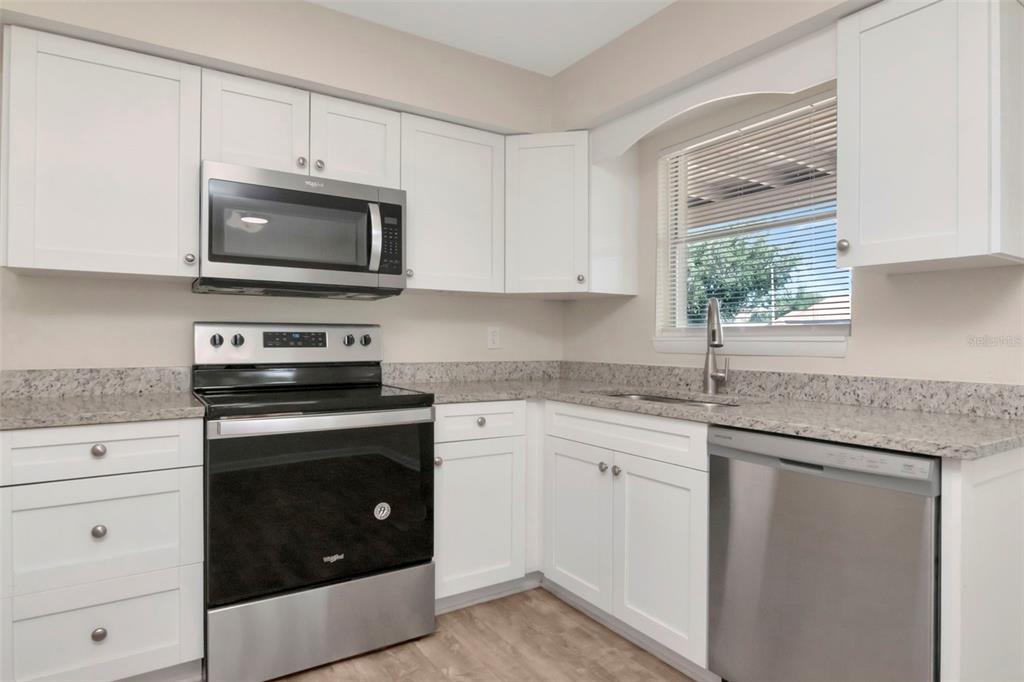 126 Kingsway Road Brandon, FL 33510 - Photo 18 of 42 a kitchen with white cabinets stainless steel appliances and sink