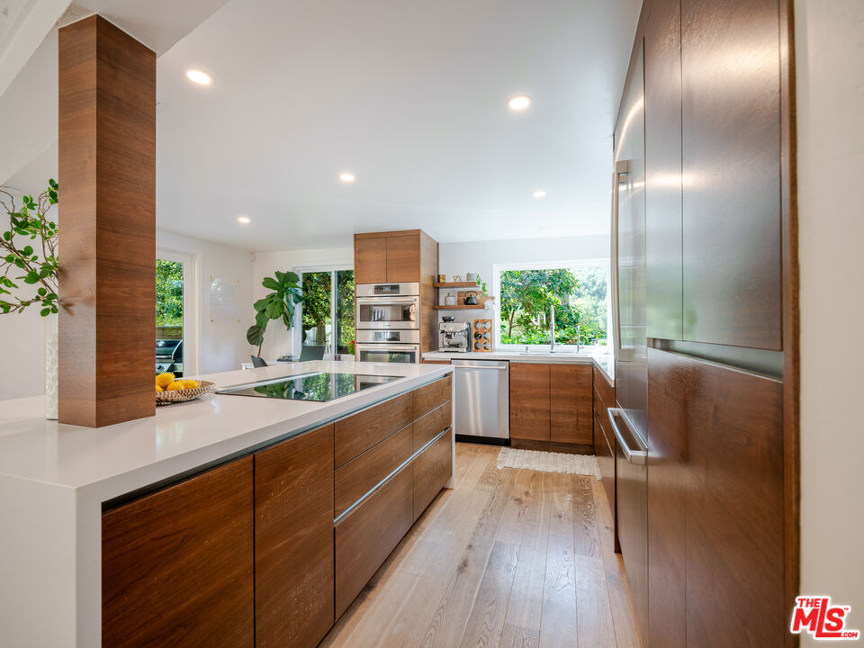 20922 Keller Road Topanga, CA 90290 - Photo 14 of 49 a large white kitchen with a large window