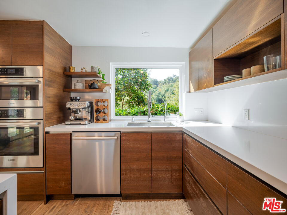 20922 Keller Road Topanga, CA 90290 - Photo 15 of 49 a kitchen with cabinets a window and stainless steel appliances
