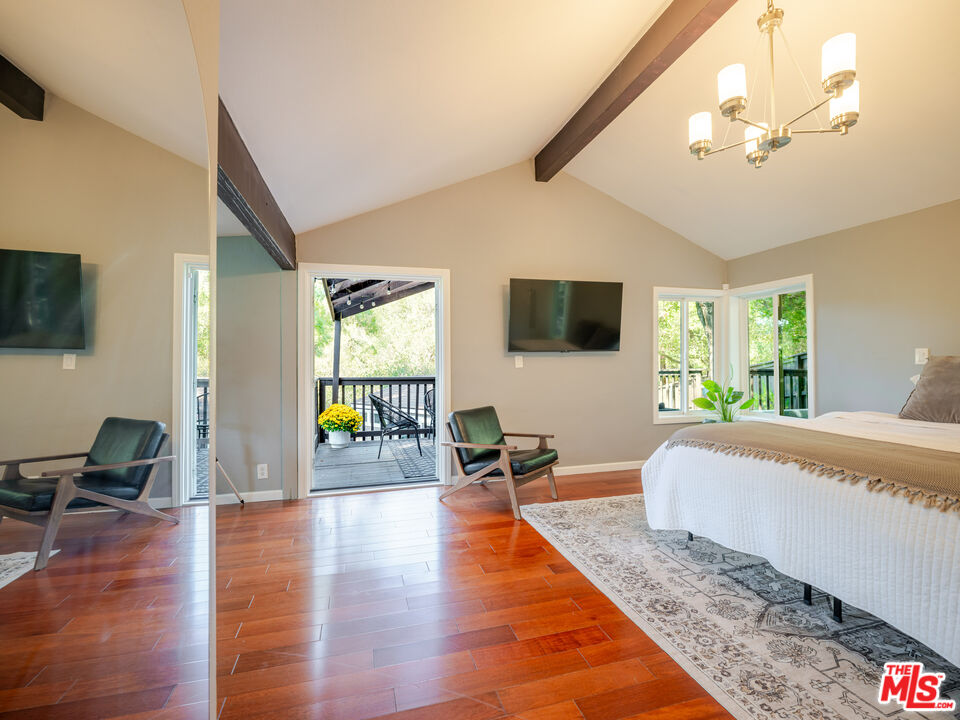 20922 Keller Road Topanga, CA 90290 - Photo 28 of 49 a living room with furniture and a flat screen tv