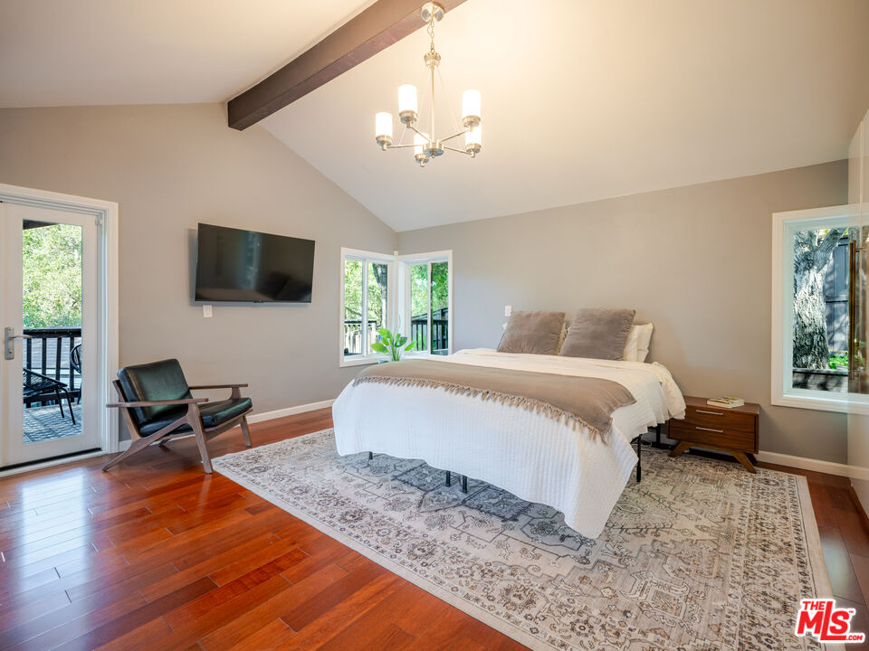 20922 Keller Road Topanga, CA 90290 - Photo 33 of 49 a bedroom with a bed window and a flat screen tv
