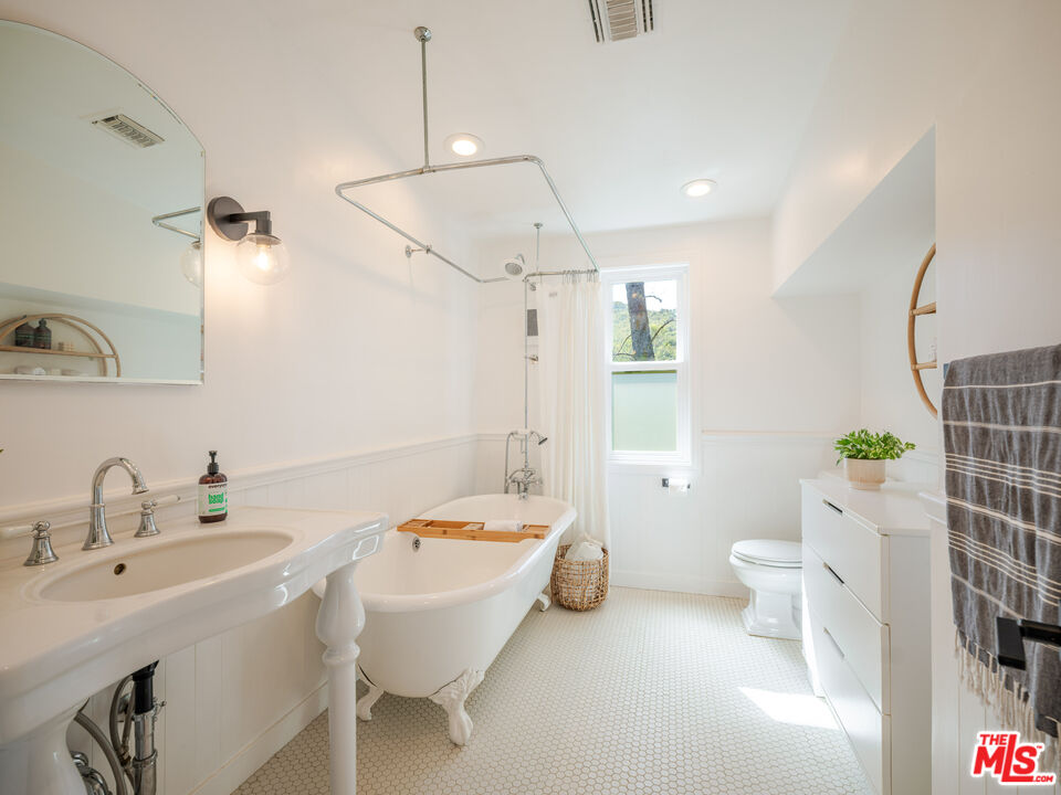 20922 Keller Road Topanga, CA 90290 - Photo 34 of 49 a bathroom with a sink a toilet and shower