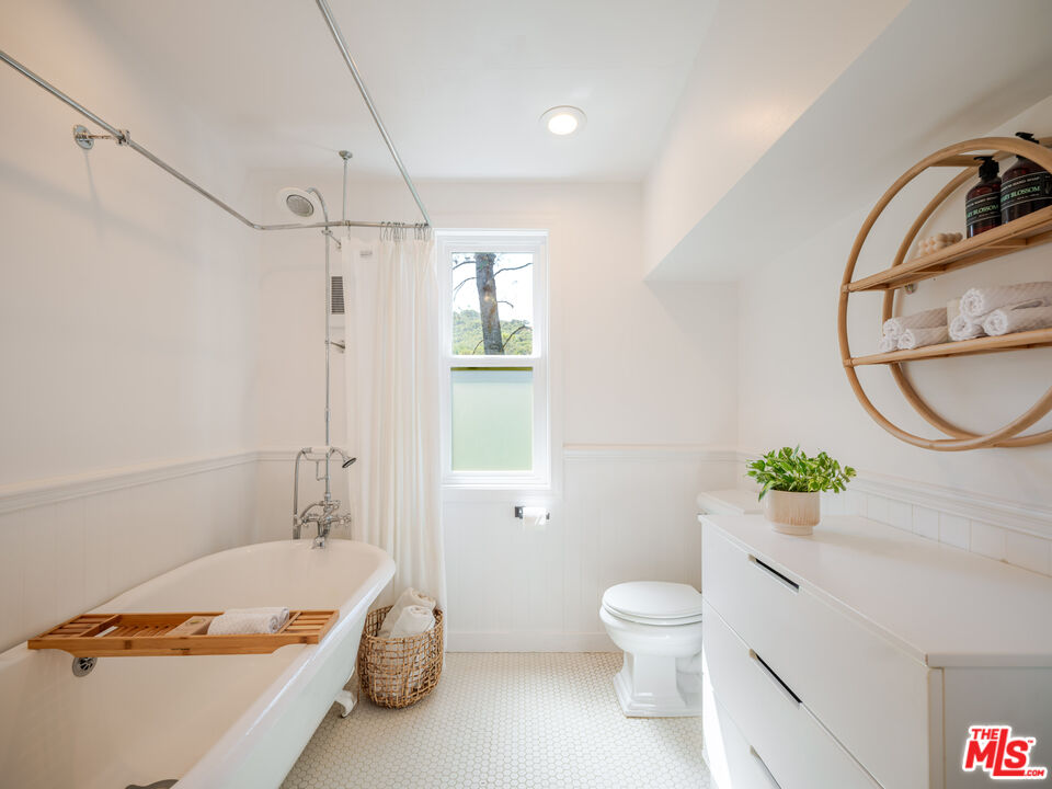 20922 Keller Road Topanga, CA 90290 - Photo 35 of 49 a bathroom with a granite countertop sink a toilet and shower