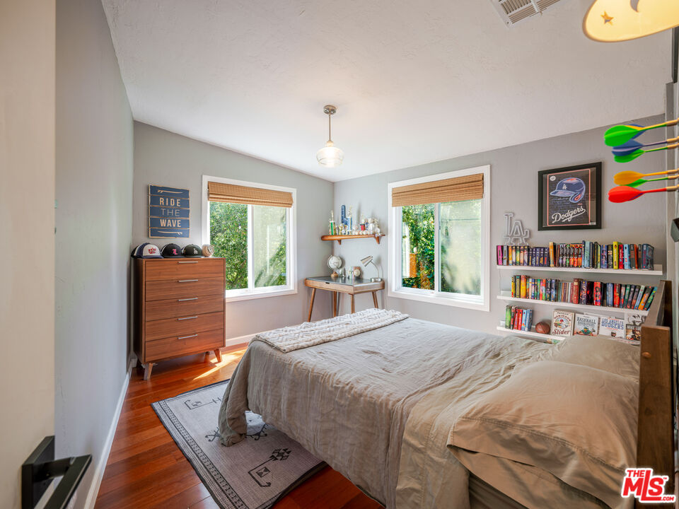 20922 Keller Road Topanga, CA 90290 - Photo 36 of 49 a bedroom with a bed and a book shelf
