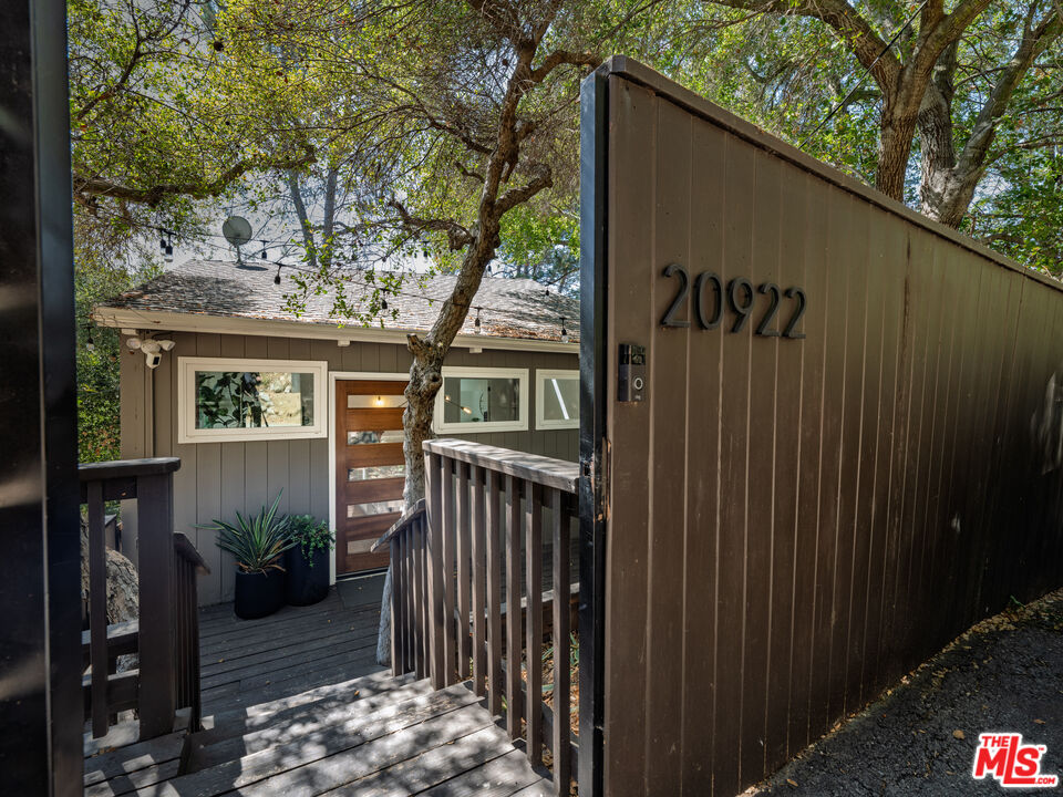 20922 Keller Road Topanga, CA 90290 - Photo 38 of 49 a view of a house with a tree in the background