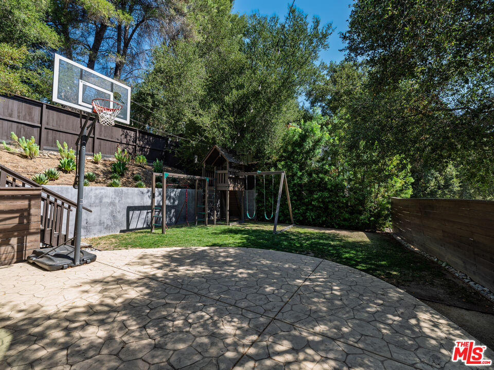 20922 Keller Road Topanga, CA 90290 - Photo 8 of 49 a view of a park that has large trees and a wooden fence