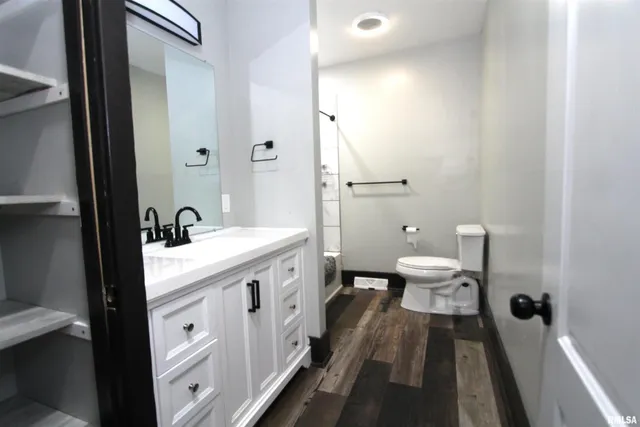 a spacious bathroom with a double vanity sink and mirror