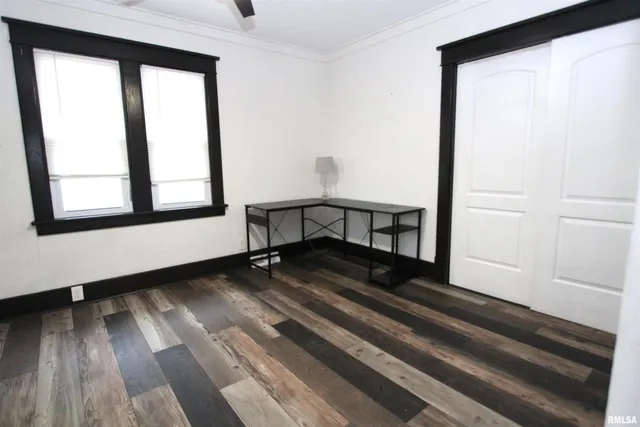 a view of a livingroom with wooden floor and a window