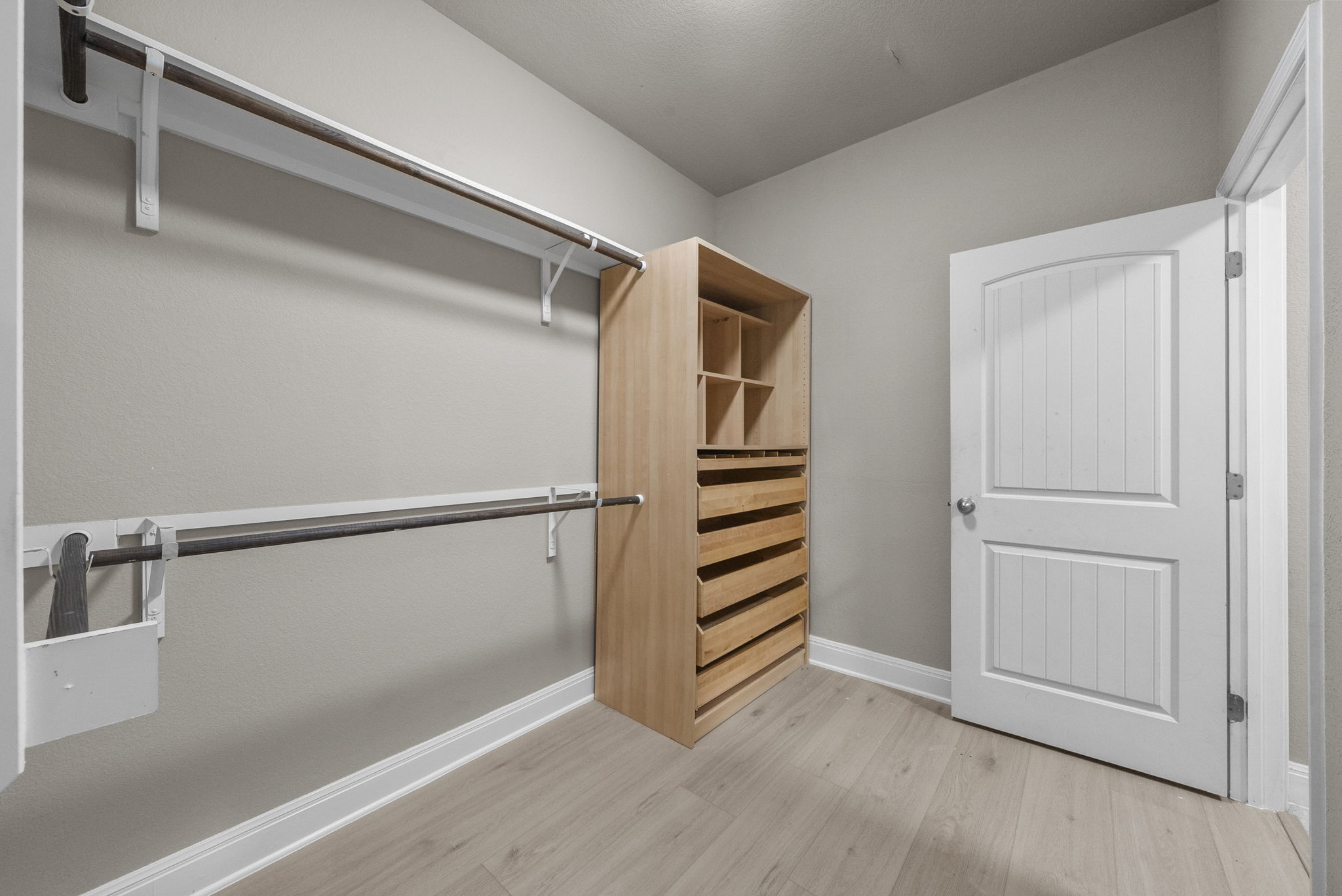 4401 Trinity Woods Street Leander, TX 78641 - Photo 18 of 37 An organized closet offers abundant storage with built-in shelving and hanging space.