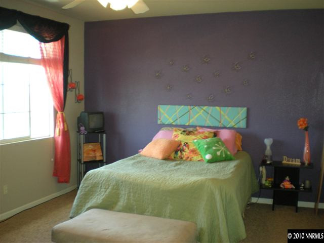 11021 Lamour Lane Reno, NV 89521 - Photo 6 of 9 a bedroom with a bed and a potted plant