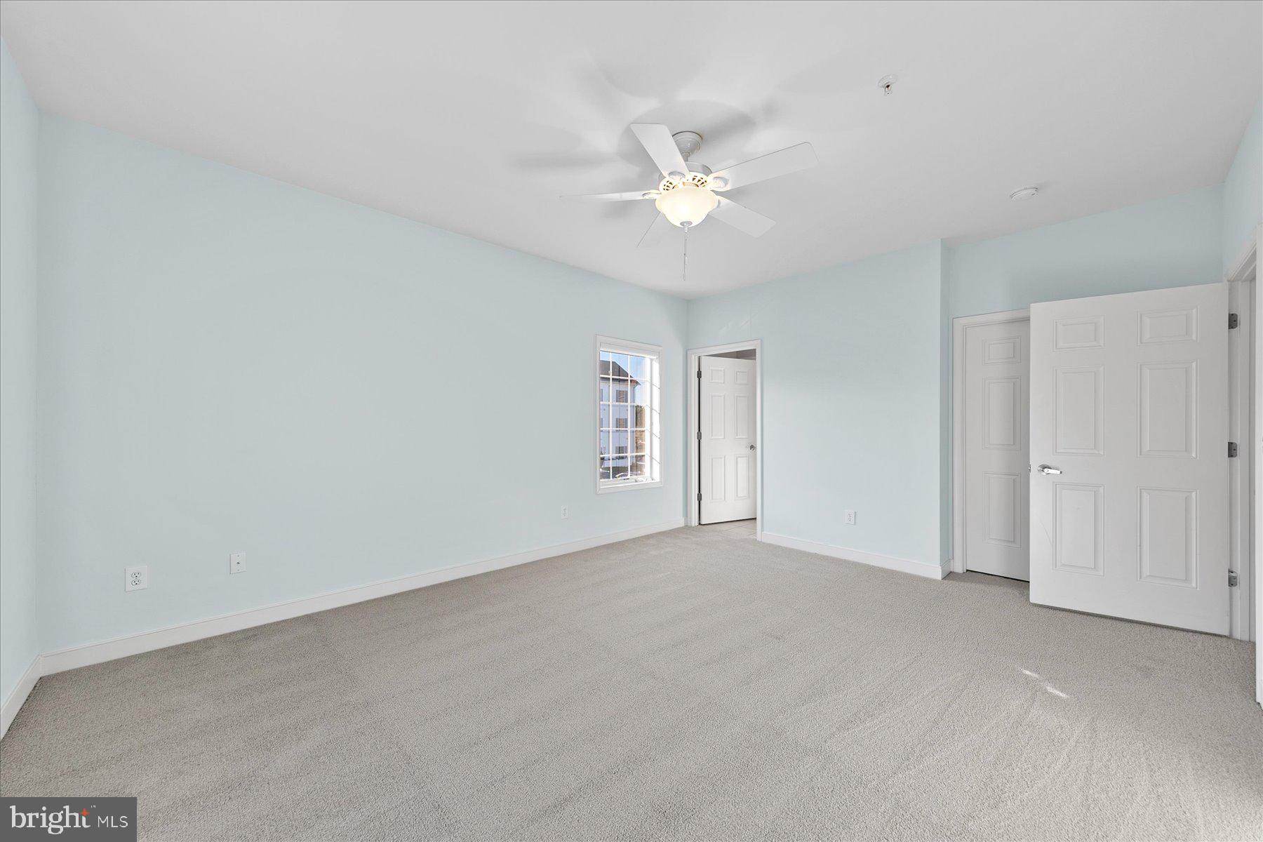30611 Cedar Neck Road, Unit 2212 Ocean View, DE 19970 - Photo 19 of 29 an empty room with a window and ceiling fan
