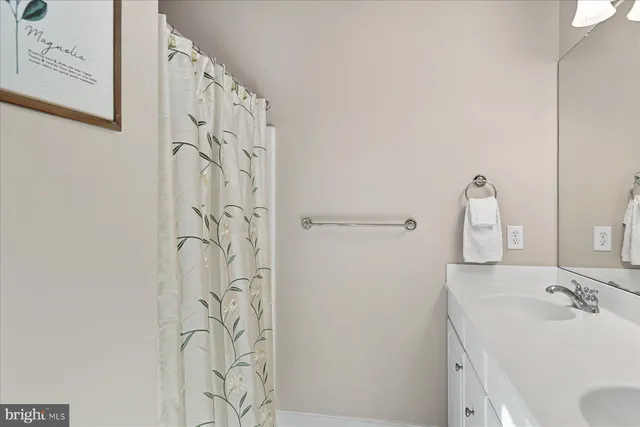 a bathroom with a sink and mirror with toilet