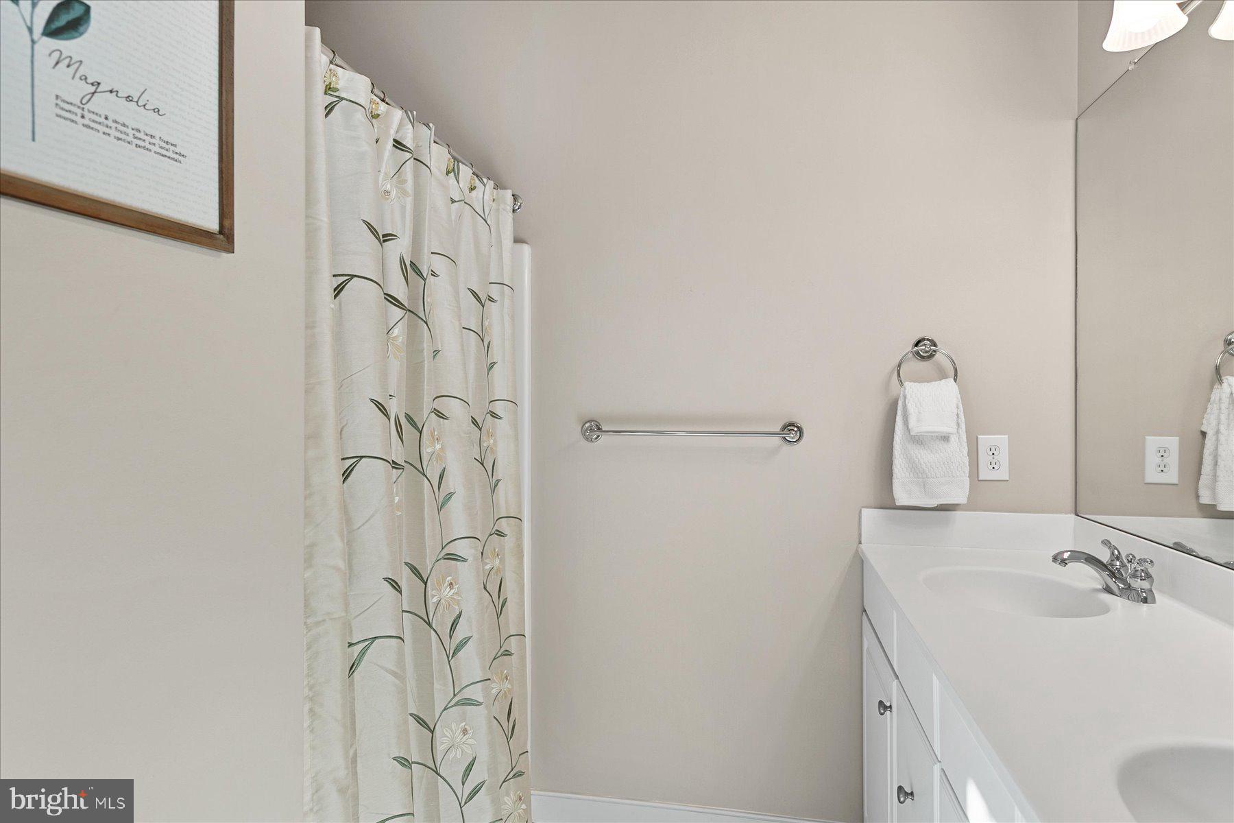30611 Cedar Neck Road, Unit 2212 Ocean View, DE 19970 - Photo 21 of 29 a bathroom with a sink and mirror with toilet