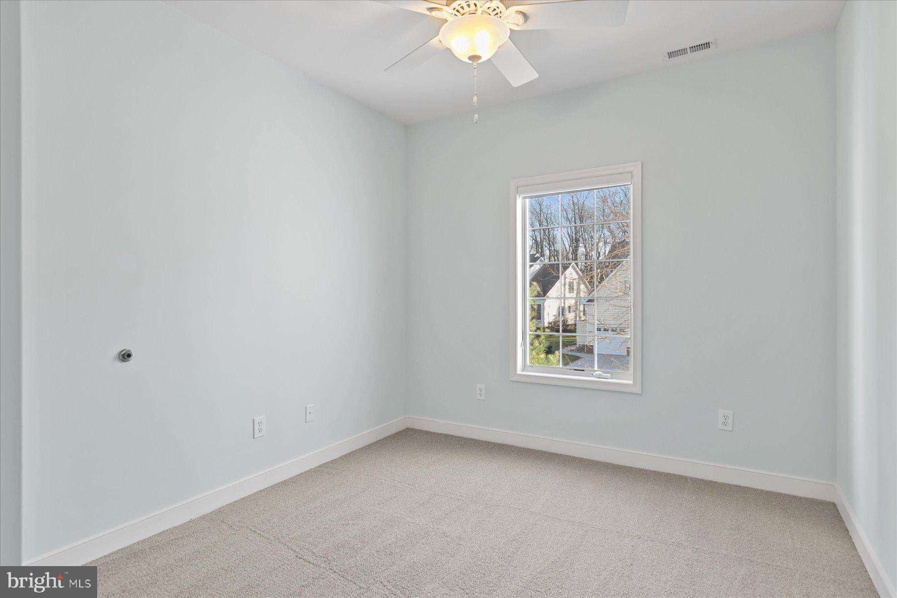 30611 Cedar Neck Road, Unit 2212 Ocean View, DE 19970 - Photo 22 of 29 an empty room with a window