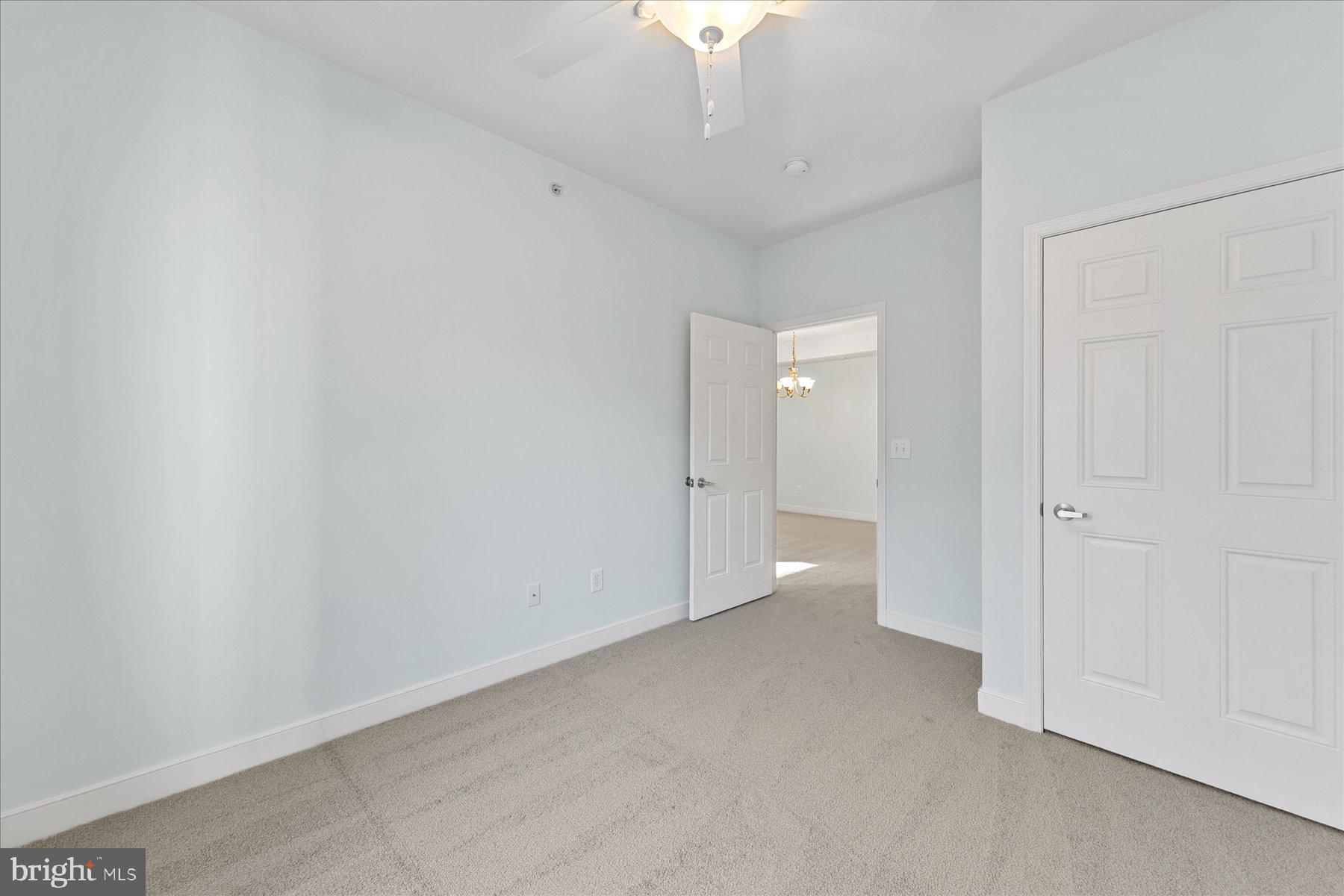 30611 Cedar Neck Road, Unit 2212 Ocean View, DE 19970 - Photo 23 of 29 a view of an empty room and chandelier fan
