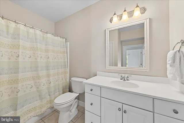 a bathroom with a sink toilet a mirror and shower