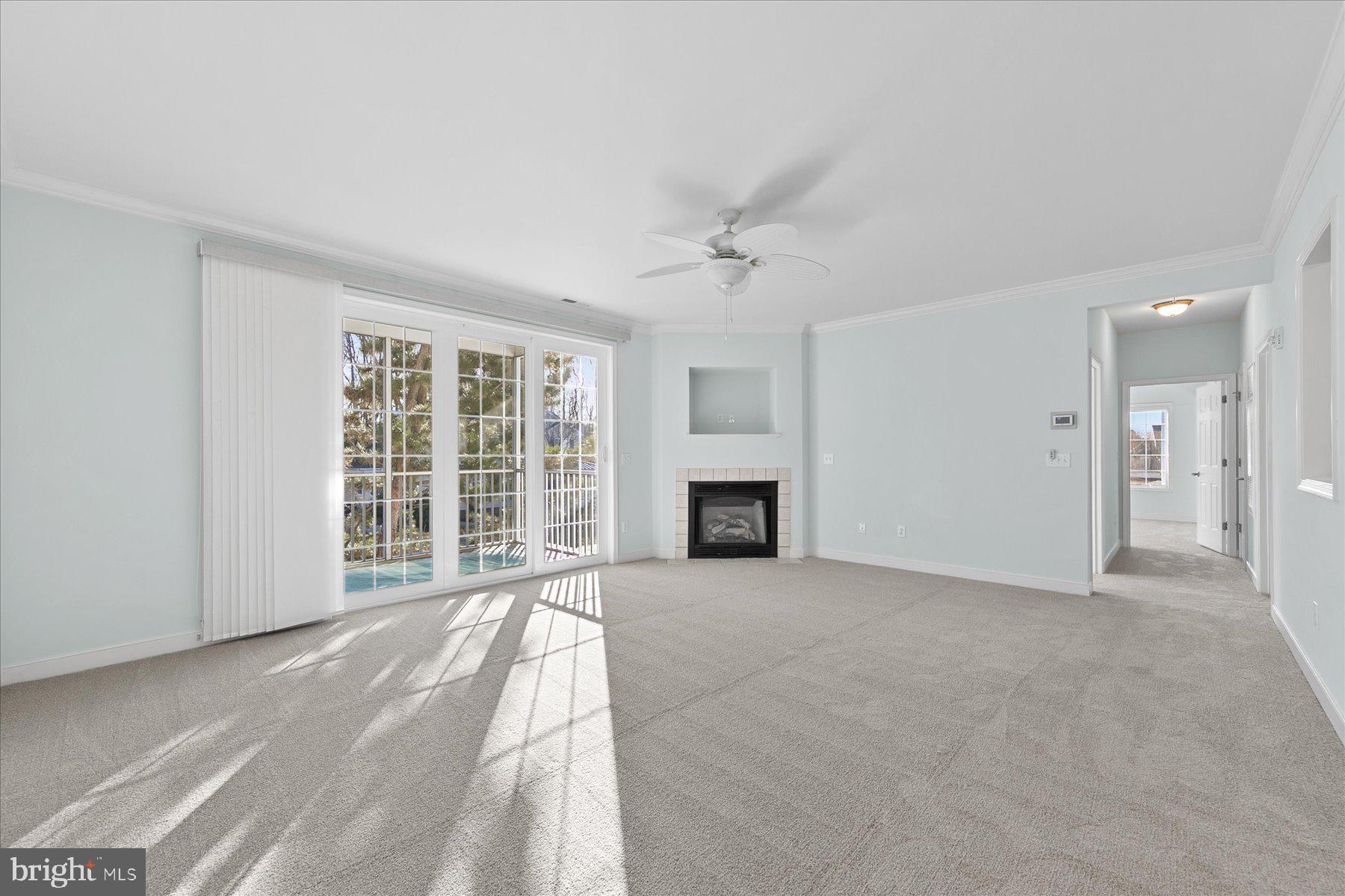 30611 Cedar Neck Road, Unit 2212 Ocean View, DE 19970 - Photo 3 of 29 a view of an empty room with a fireplace and a window