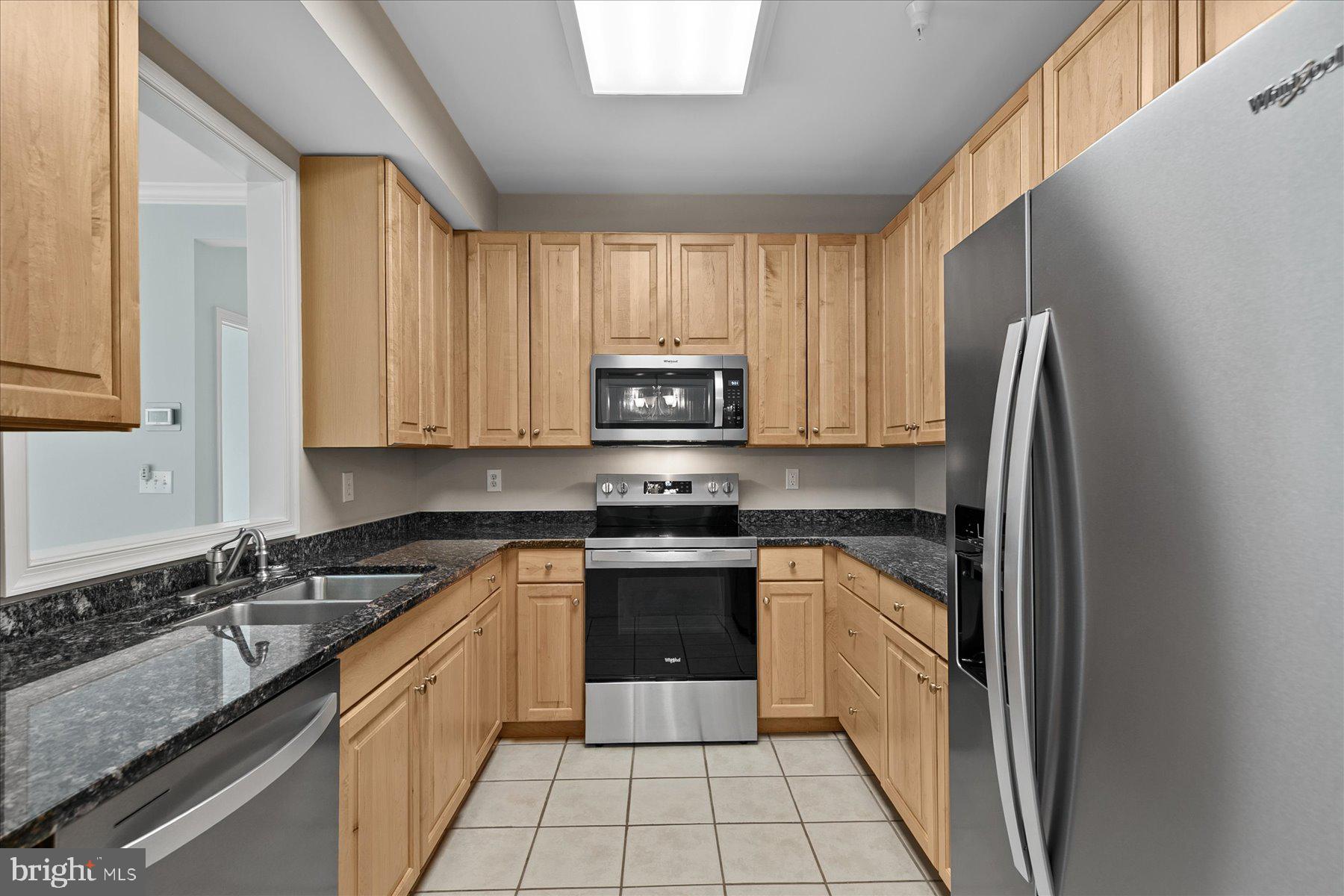 30611 Cedar Neck Road, Unit 2212 Ocean View, DE 19970 - Photo 7 of 29 a kitchen with a sink stove and cabinets