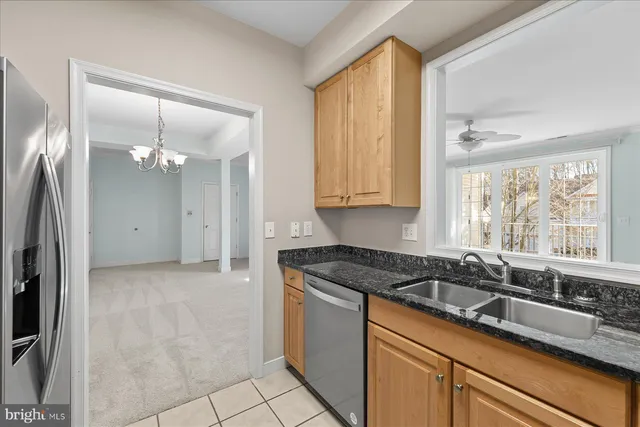 a kitchen with a sink window and cabinets