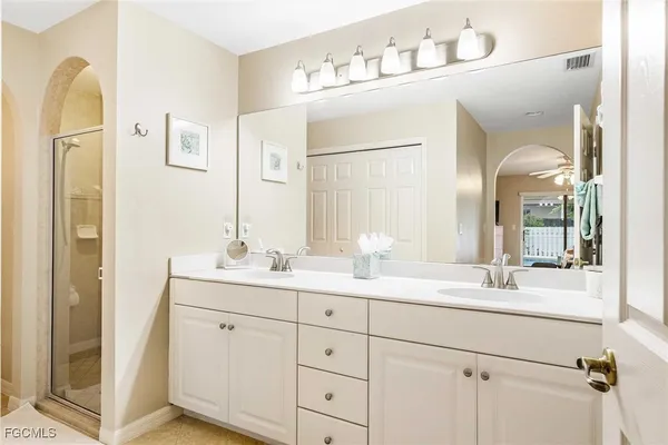 a bathroom with a double vanity sink and mirror