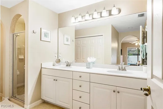 a bathroom with a double vanity sink and mirror