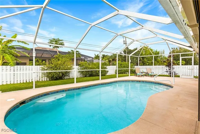 a view of a backyard with a swimming pool