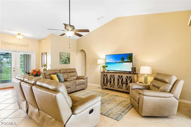 a living room with furniture a ceiling fan and a rug