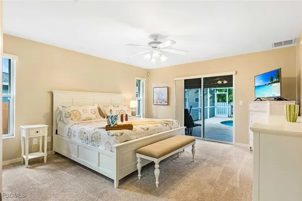 a bedroom with a bed and large window
