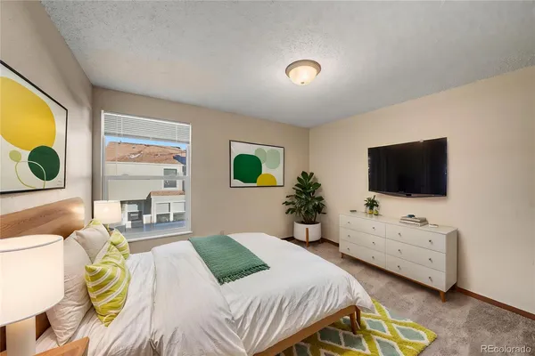 a bedroom with a bed and flat screen tv