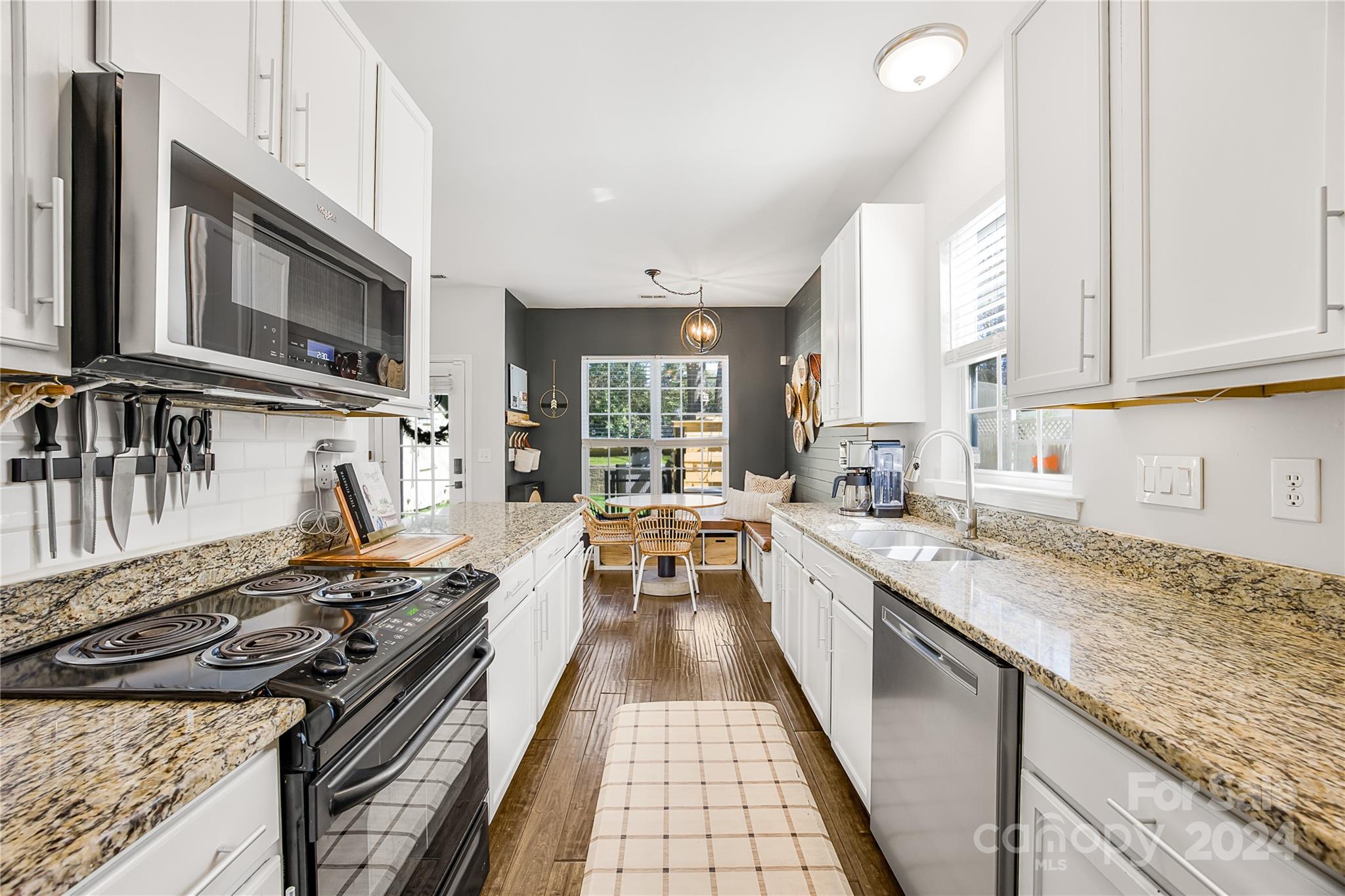 1214 Rising Oak Drive Charlotte, NC 28206 - Photo 12 of 38 a kitchen with stainless steel appliances granite countertop a stove and a sink