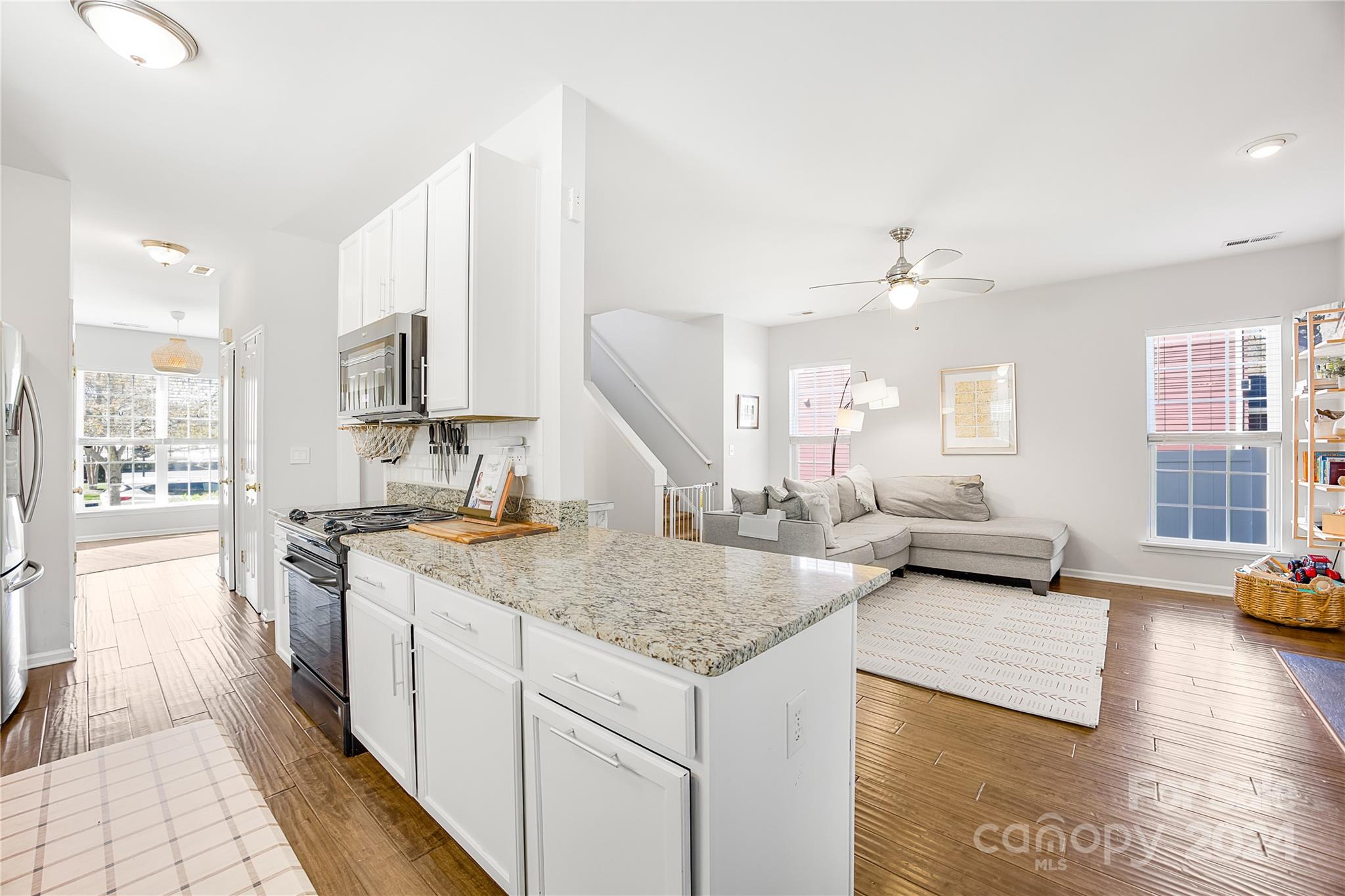 1214 Rising Oak Drive Charlotte, NC 28206 - Photo 13 of 38 a kitchen with stainless steel appliances granite countertop a stove and a sink