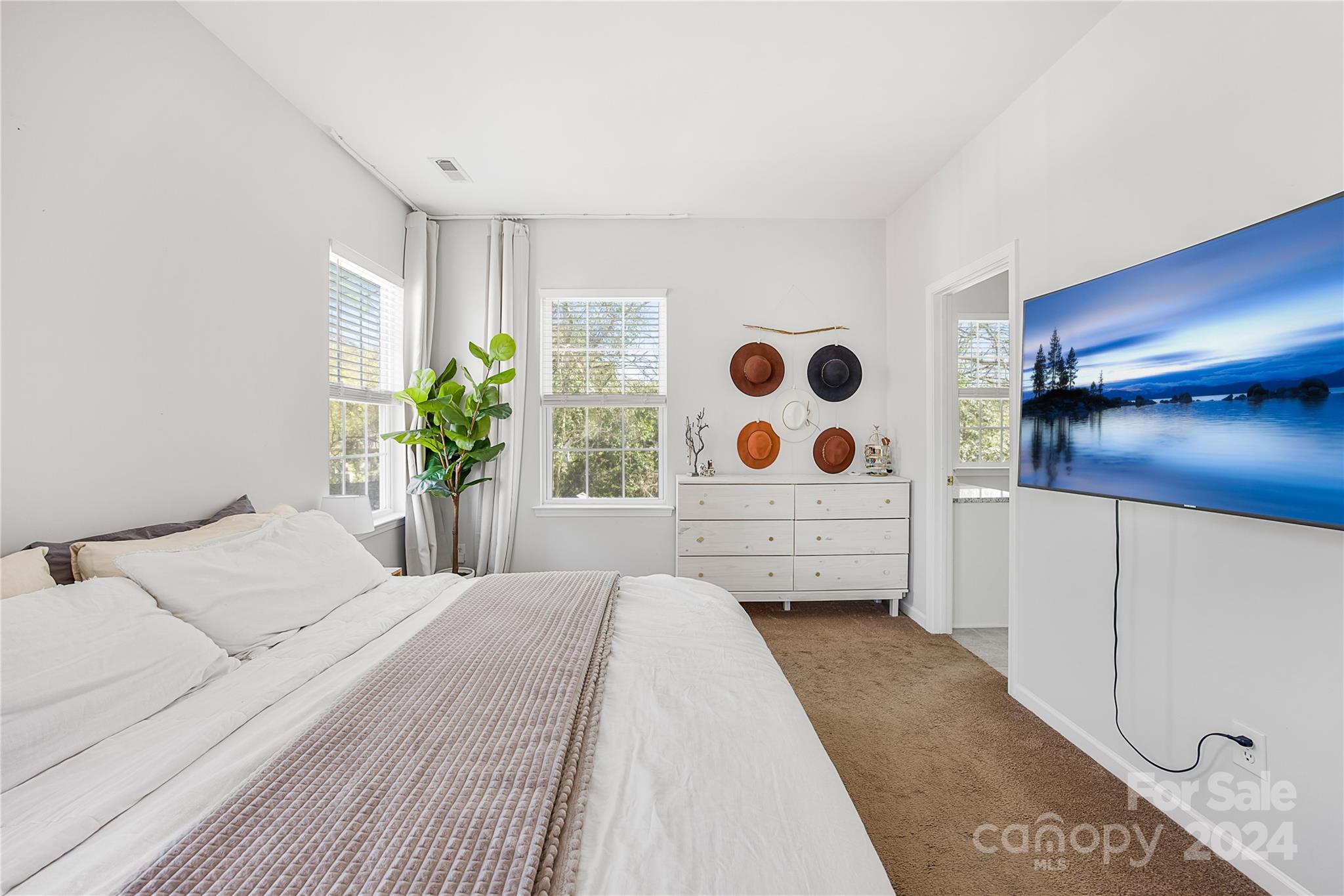 1214 Rising Oak Drive Charlotte, NC 28206 - Photo 21 of 38 a bedroom with a bed and a potted plant