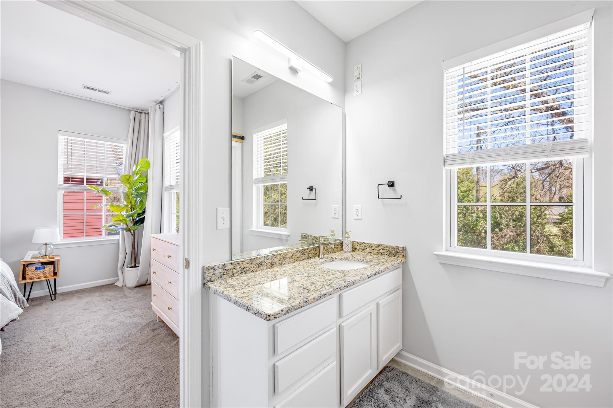 1214 Rising Oak Drive Charlotte, NC 28206 - Photo 23 of 38 a bathroom with a granite countertop sink and a window