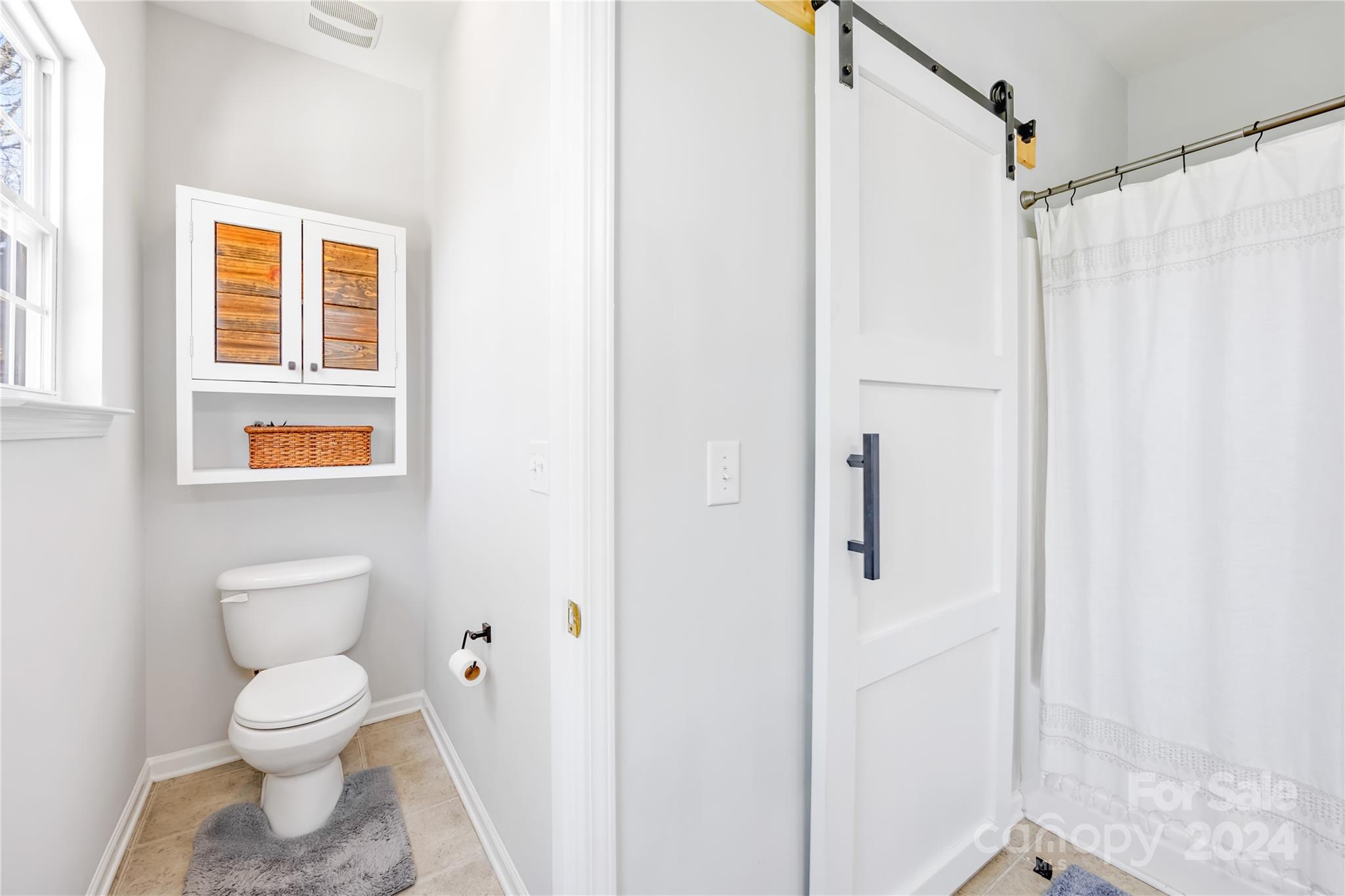 1214 Rising Oak Drive Charlotte, NC 28206 - Photo 24 of 38 a bathroom with a toilet and a shower