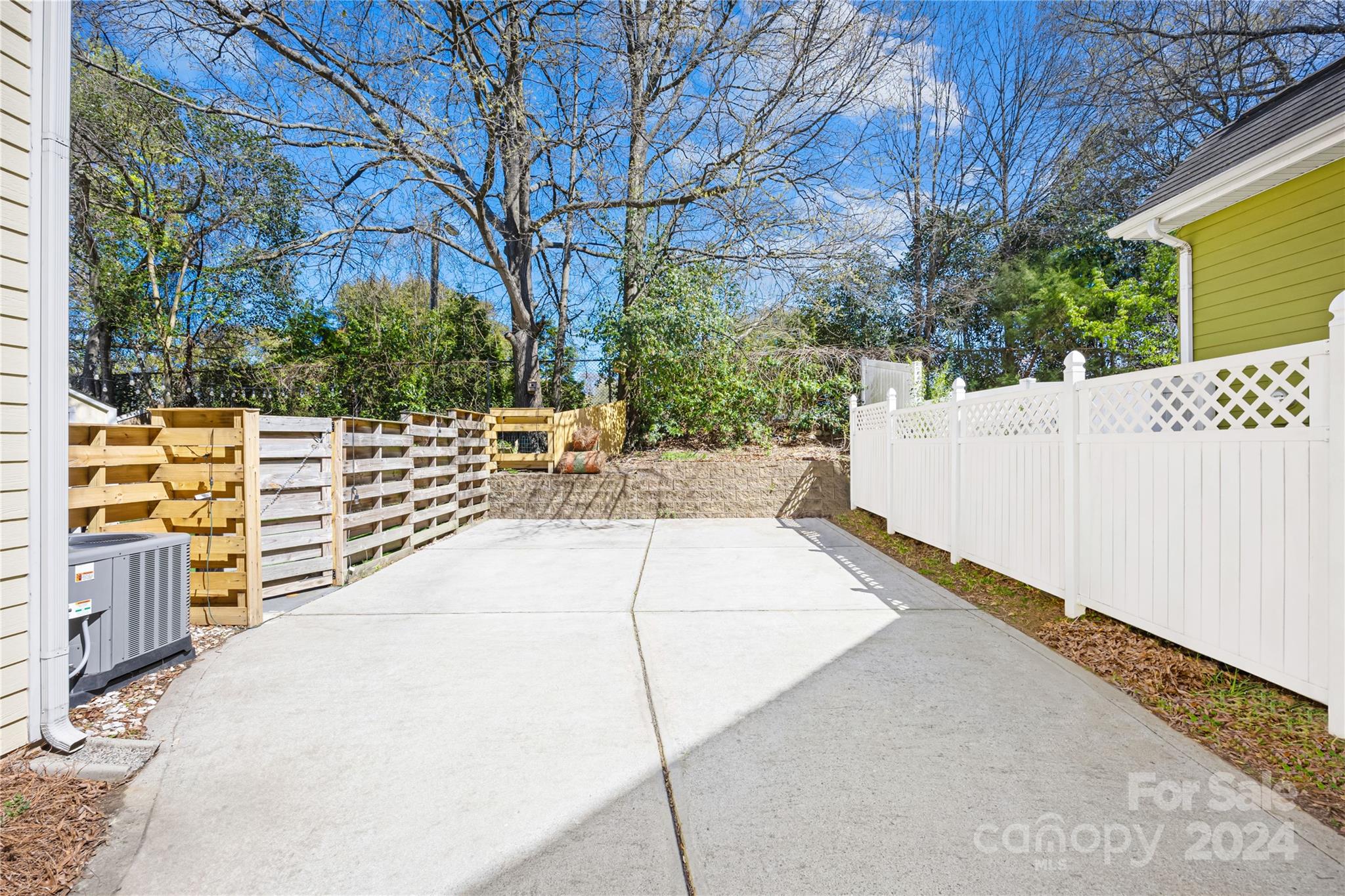 1214 Rising Oak Drive Charlotte, NC 28206 - Photo 32 of 38 a view of a patio with table and chairs and wooden fence