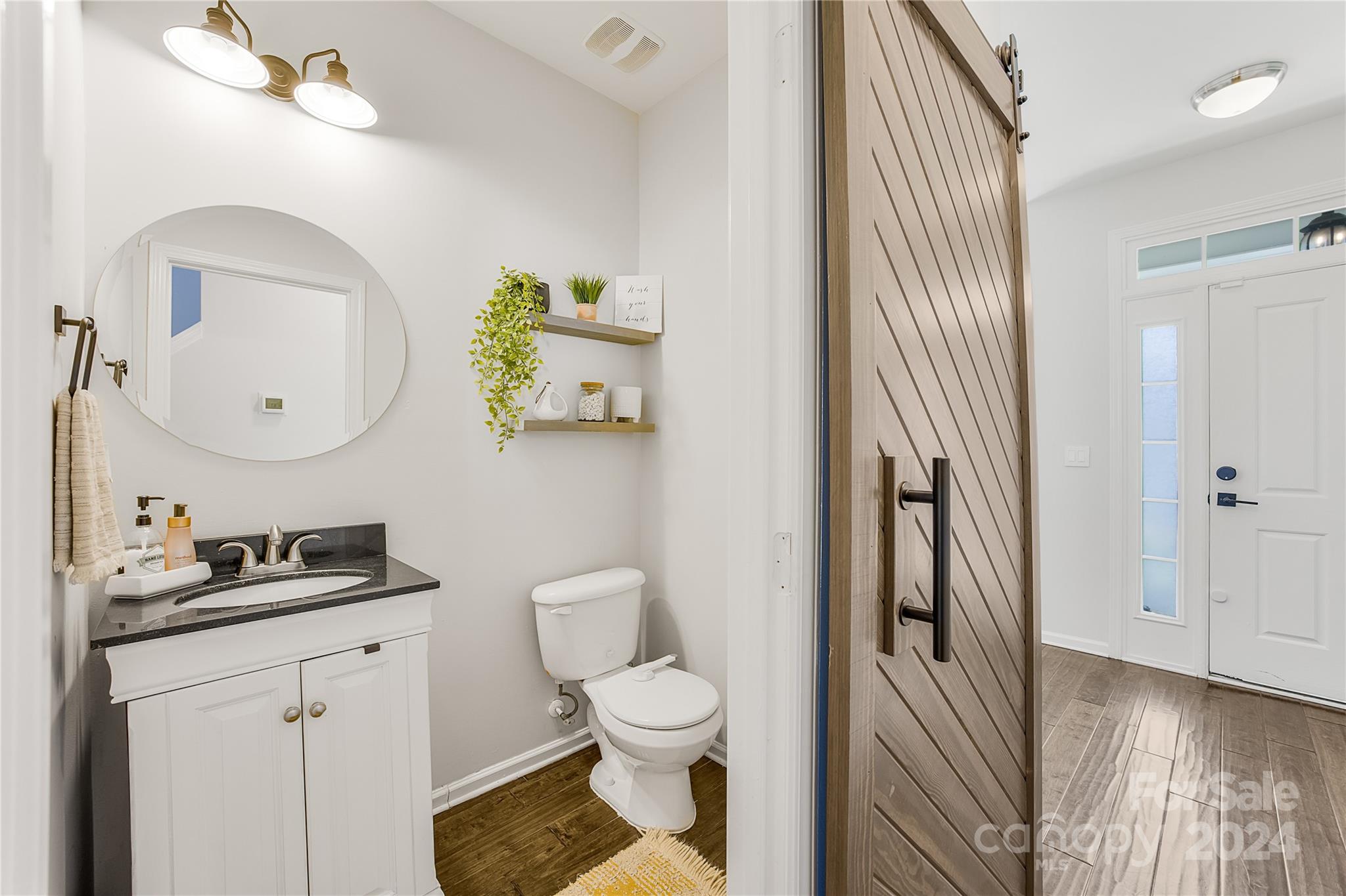 1214 Rising Oak Drive Charlotte, NC 28206 - Photo 10 of 38 a bathroom with a granite countertop toilet sink and mirror
