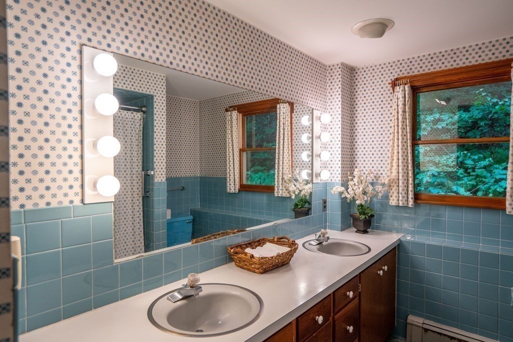 30 Harris Mountain Road Amherst, MA 01002 - Photo 24 of 42 a bathroom with a granite countertop sink and a mirror