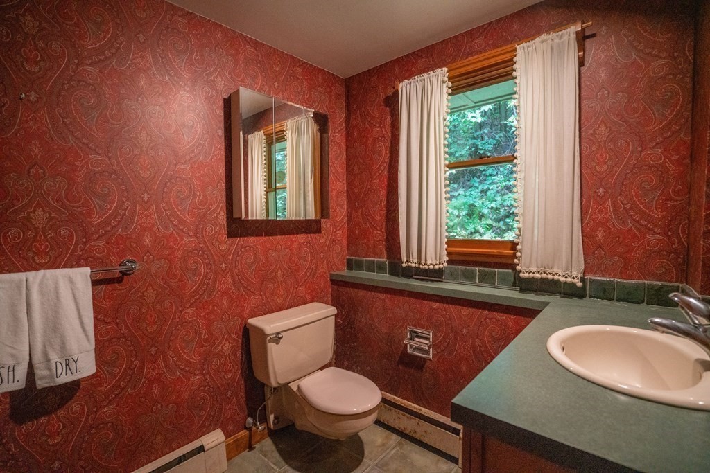 30 Harris Mountain Road Amherst, MA 01002 - Photo 26 of 42 a bathroom with a granite countertop toilet sink and mirror