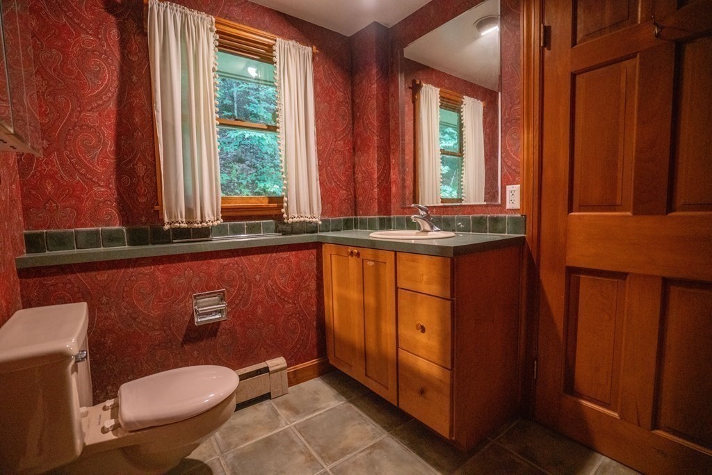 30 Harris Mountain Road Amherst, MA 01002 - Photo 27 of 42 a bathroom with a toilet a sink and mirror