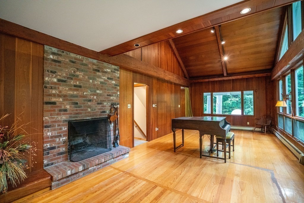 30 Harris Mountain Road Amherst, MA 01002 - Photo 9 of 42 a dining room with furniture a fireplace and wooden floor