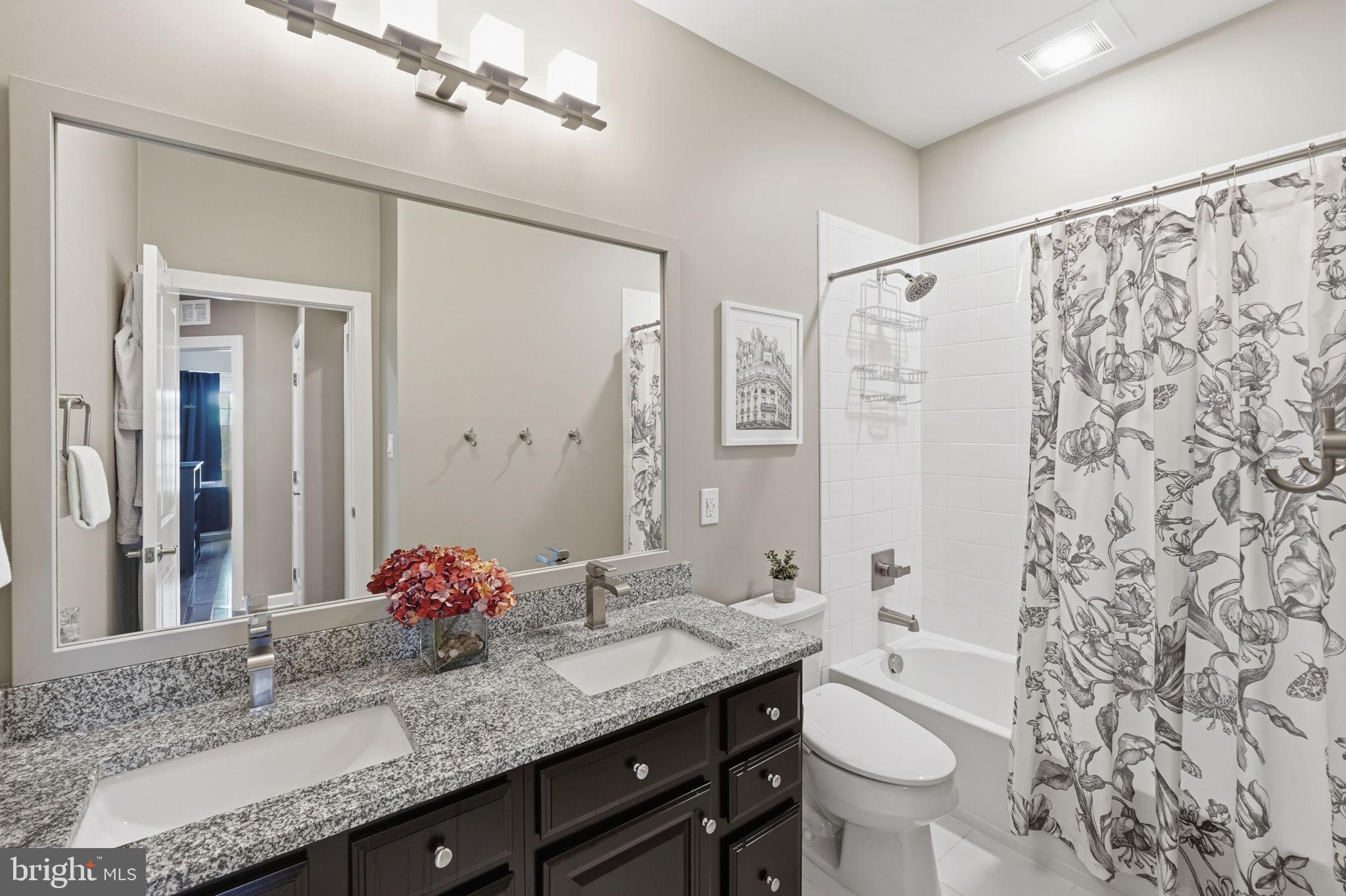17812 Thomas Village Lane Sandy Spring, MD 20860 - Photo 26 of 37 a bathroom with a granite countertop sink and a mirror