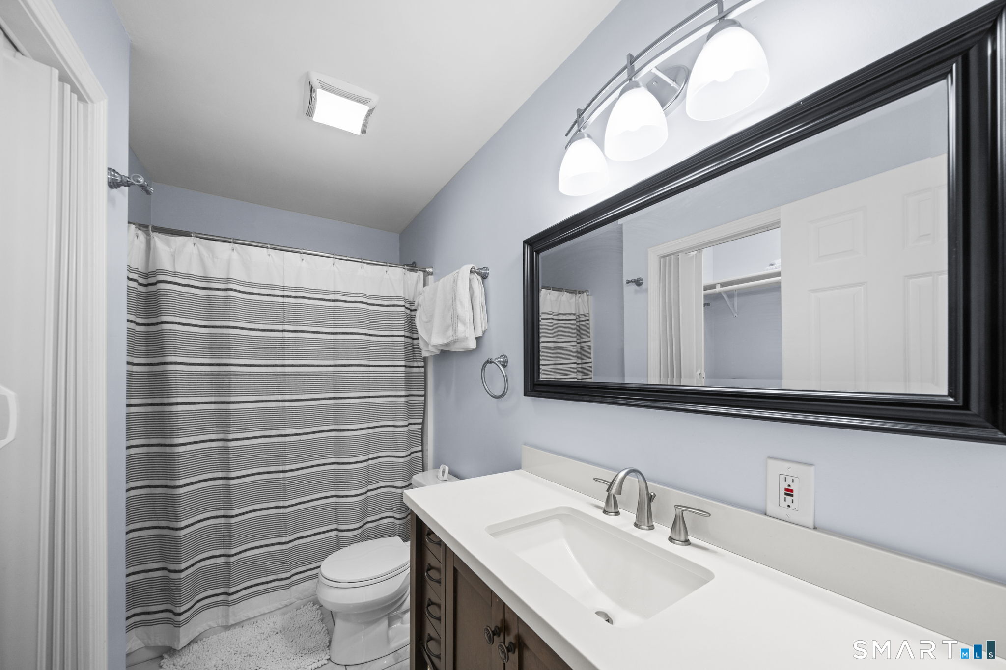 1118 Spindle Hill Road Wolcott, CT 06716 - Photo 22 of 38 a bathroom with a sink a toilet and mirror