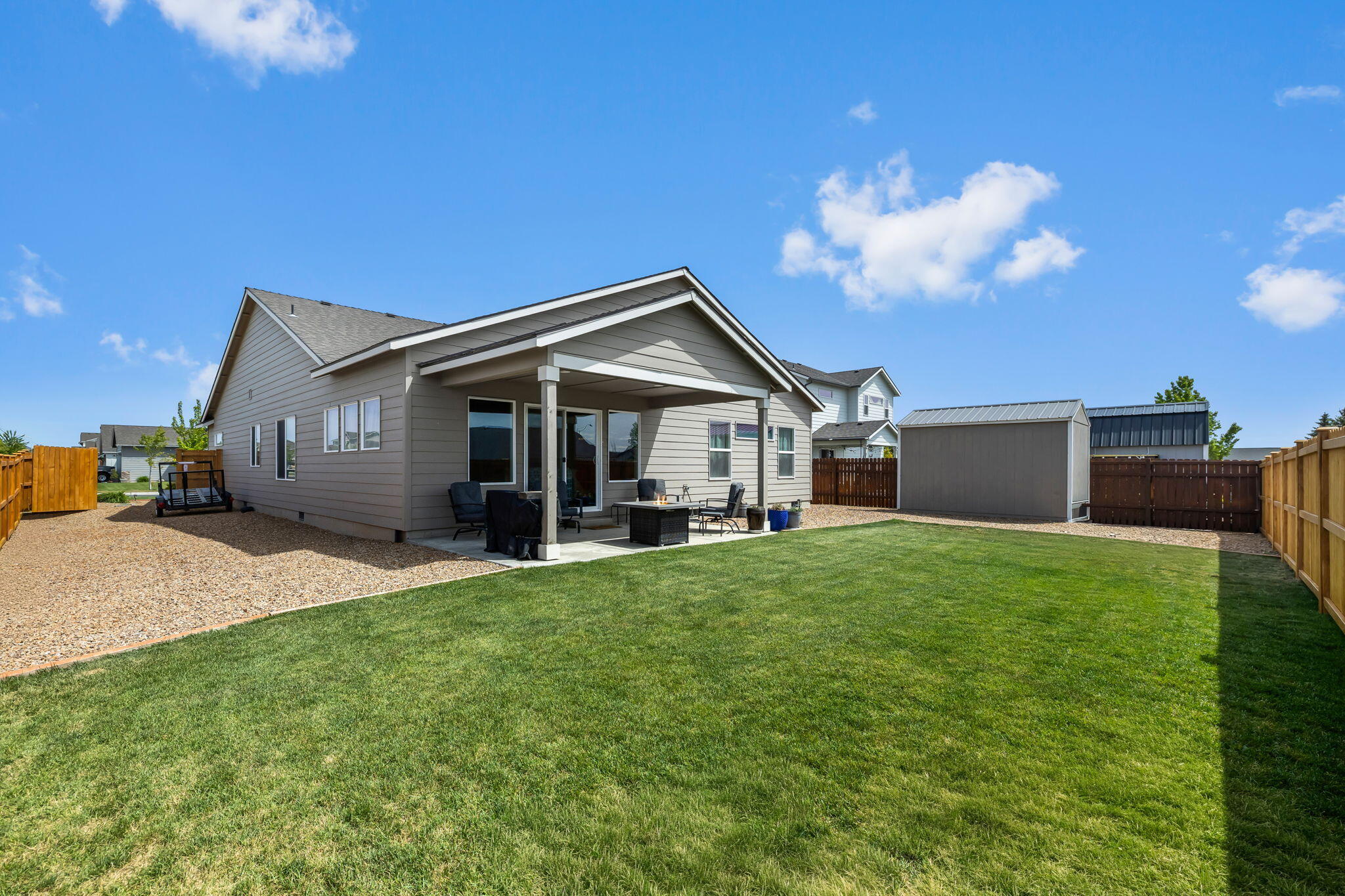 1132 Northwest Golf Course Drive Madras, OR 97741 - Photo 23 of 36 a front view of a house with a garden and yard