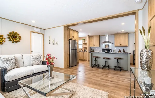 a living room with furniture and kitchen view