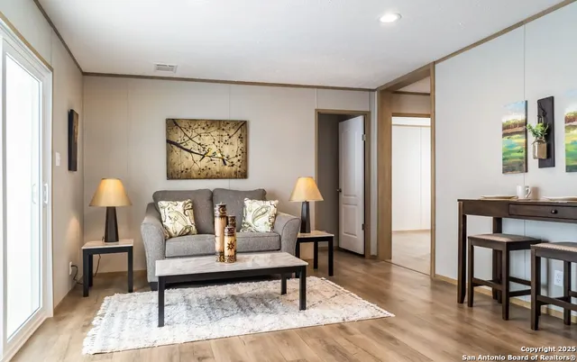 a living room with furniture and a painting on the wall