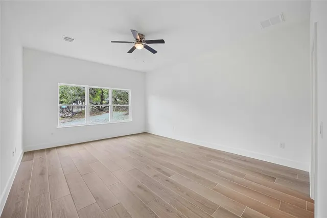 wooden floor in an empty room with a window