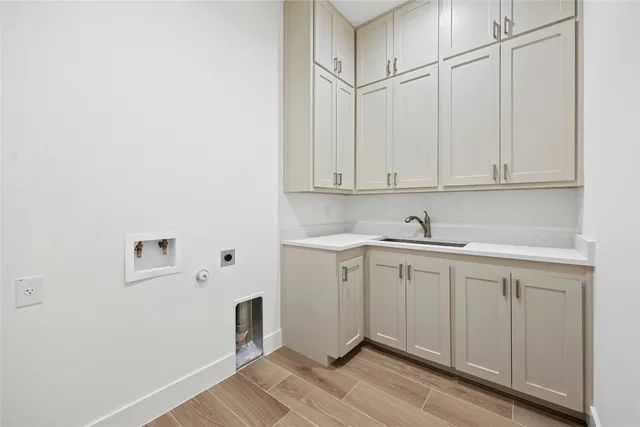 a room with a sink cabinets and wooden floor