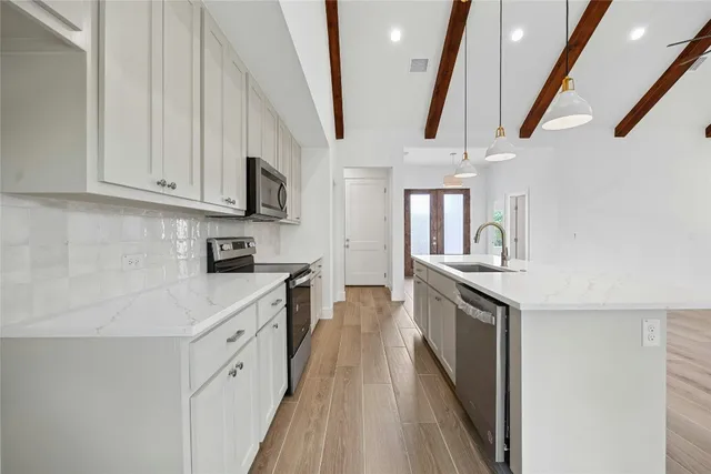 a kitchen with stainless steel appliances granite countertop a stove and a sink